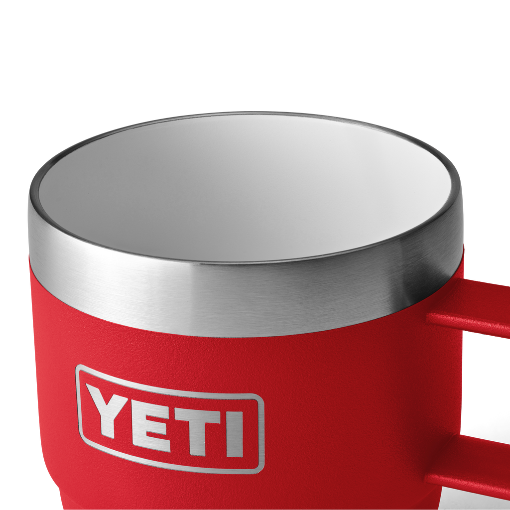Close-up red 6oz espresso mug with stainless rim and YETI logo, handle visible