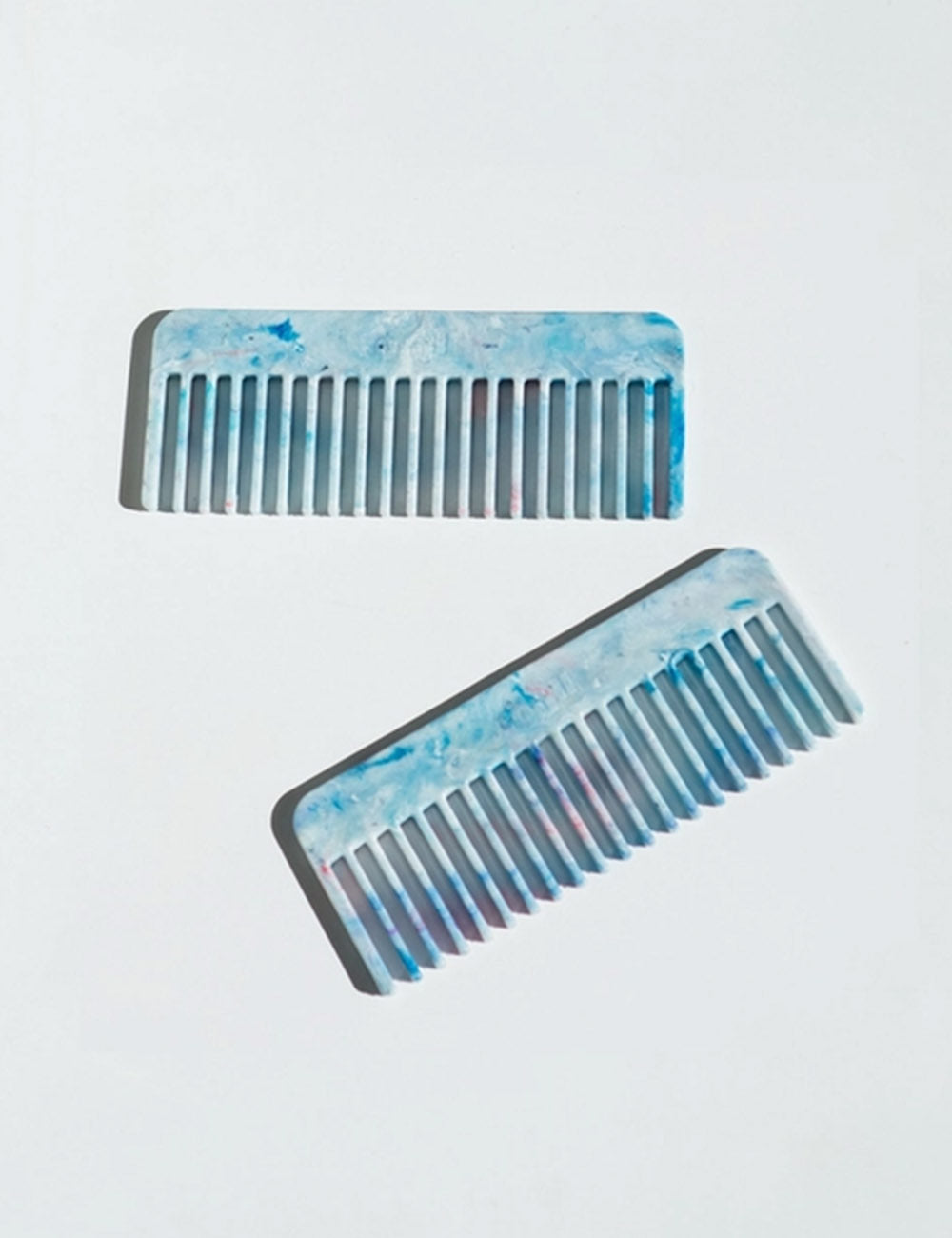 Recycled plastic comb with blue marbled finish, wide teeth in two views