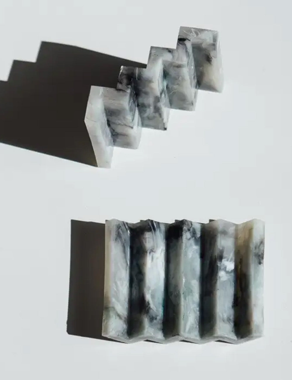 Black and white marbled soap bars on a light gray background