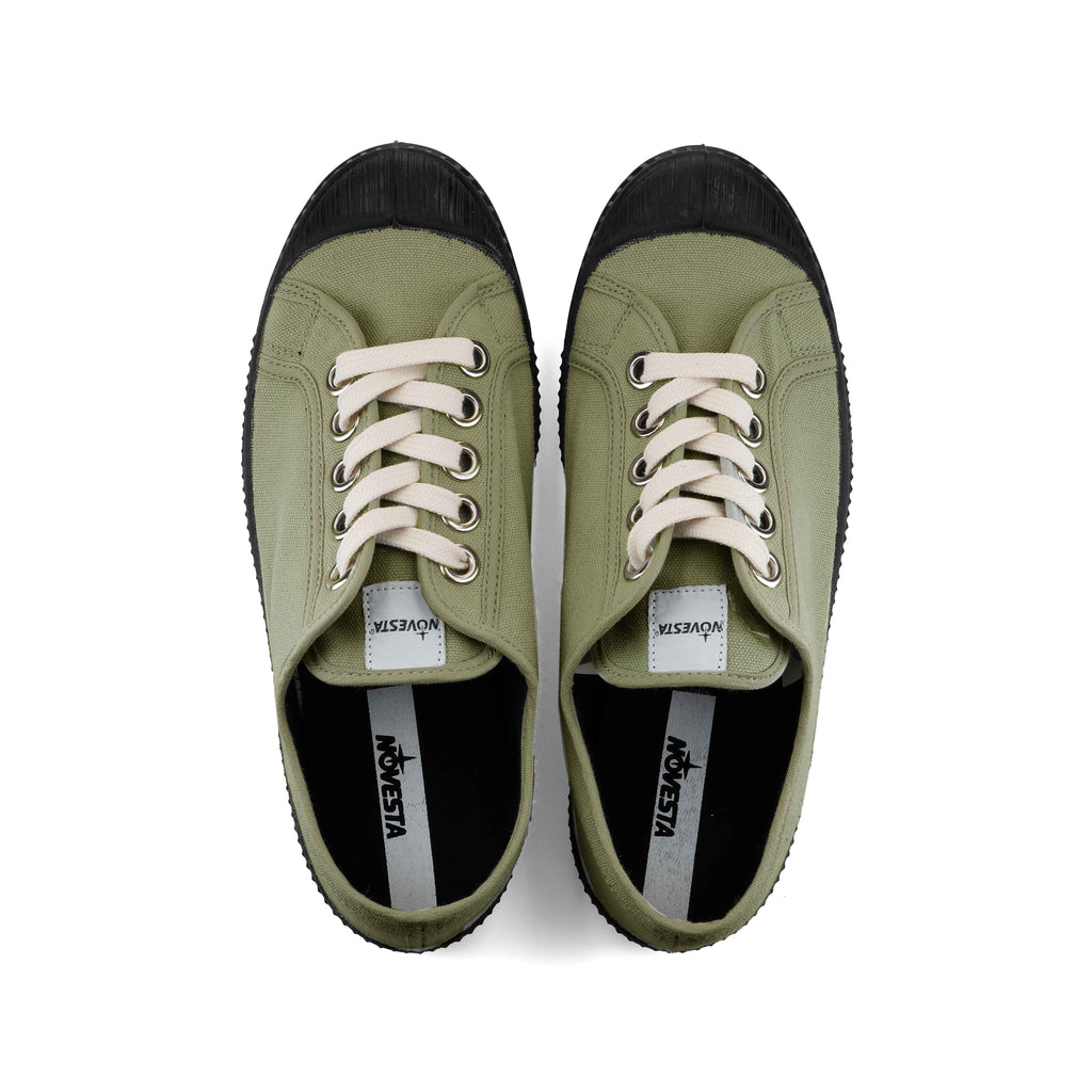 Khaki canvas lace-up sneakers with black toe, showing white inner brand label