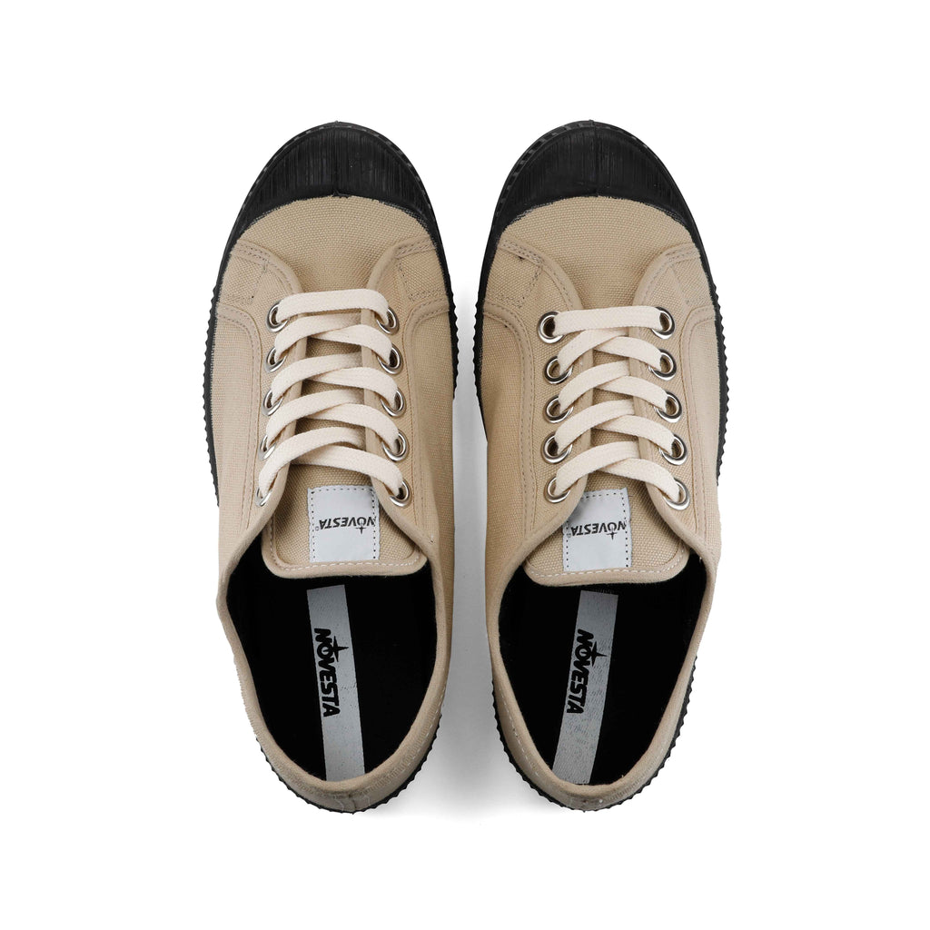 Pair of sand canvas lace-up sneakers with black inside lining and toe caps