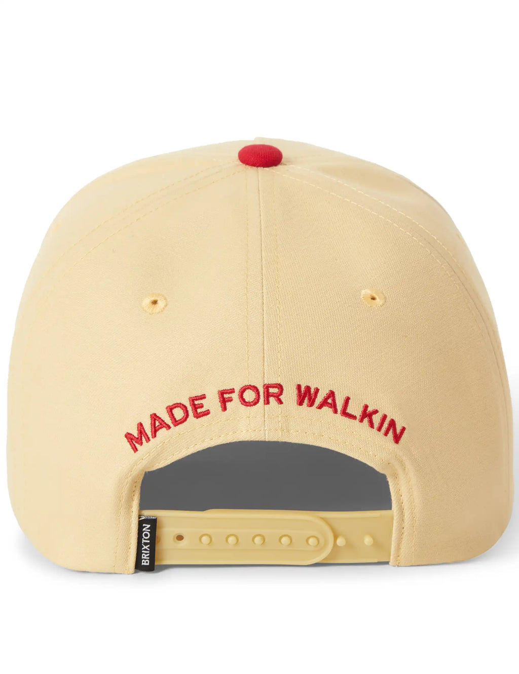 Cream snapback cap with red underbrim, 'MADE FOR WALKIN' text and strap