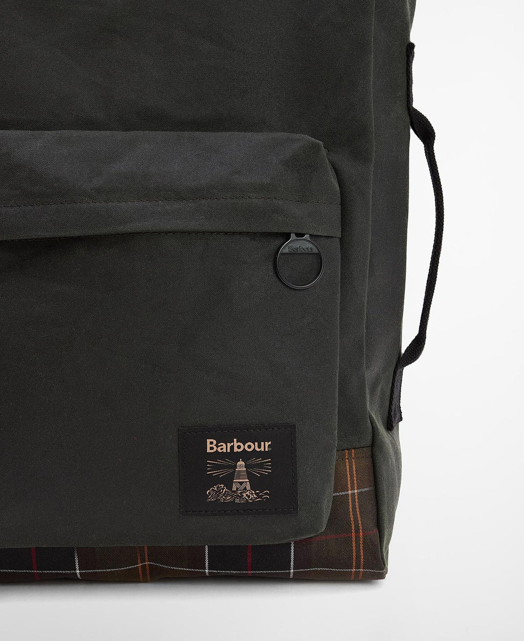 Close-up of backpack front pocket, Barbour patch, and tartan base