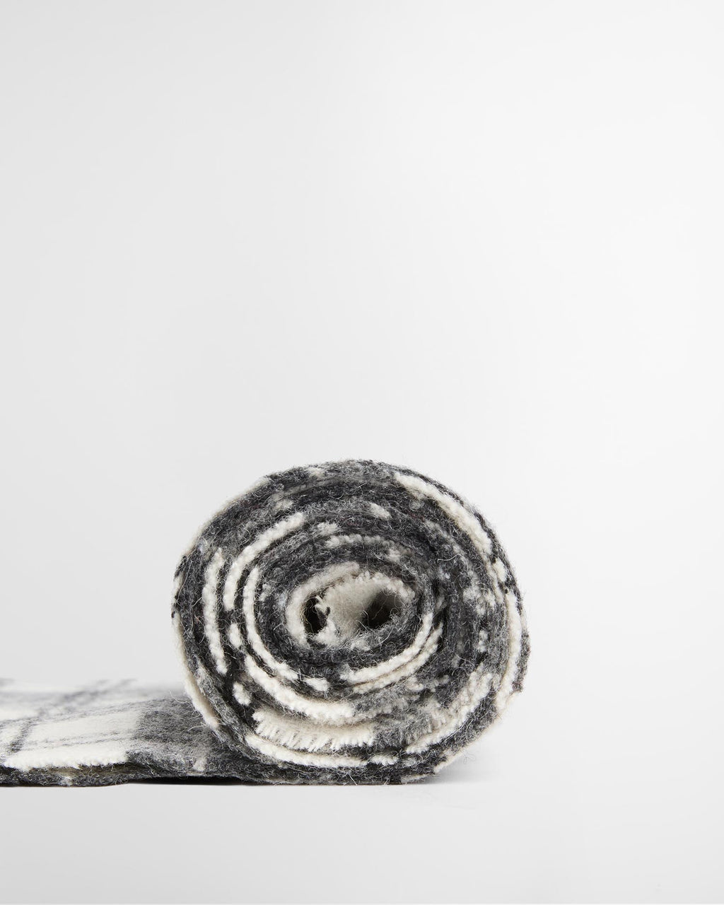Rolled monochrome tartan lambswool scarf in gray and white plaid with fringes