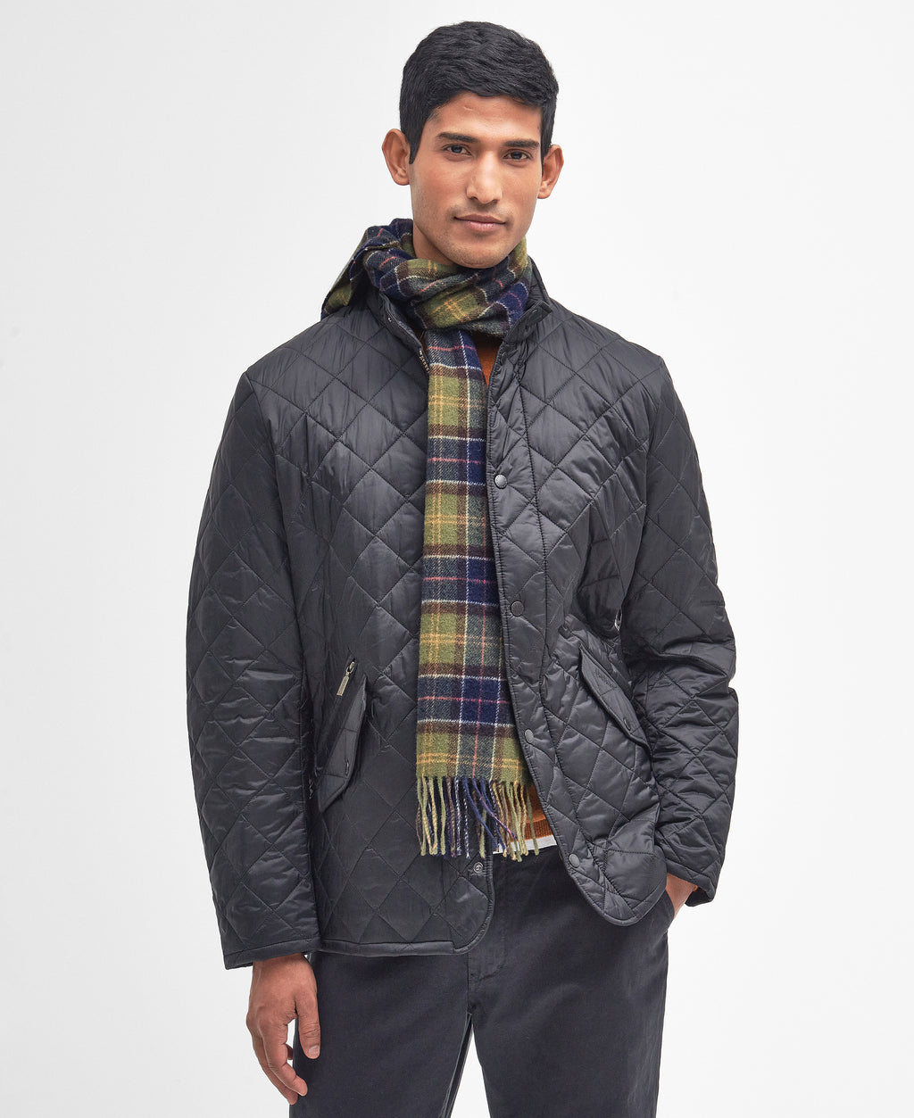 Tartan lambswool scarf with fringed ends, draped over the chest