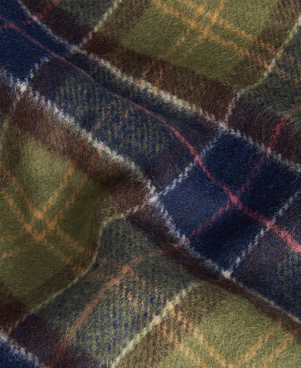 Close-up tartan lambswool scarf fabric in green, navy, and brown plaid with red lines