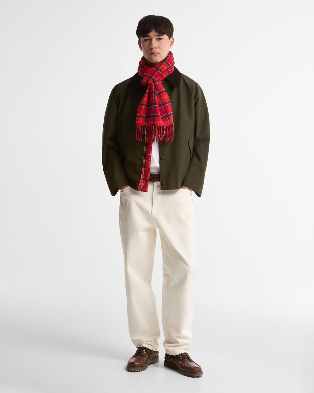 Red tartan lambswool scarf with fringe worn with a dark jacket