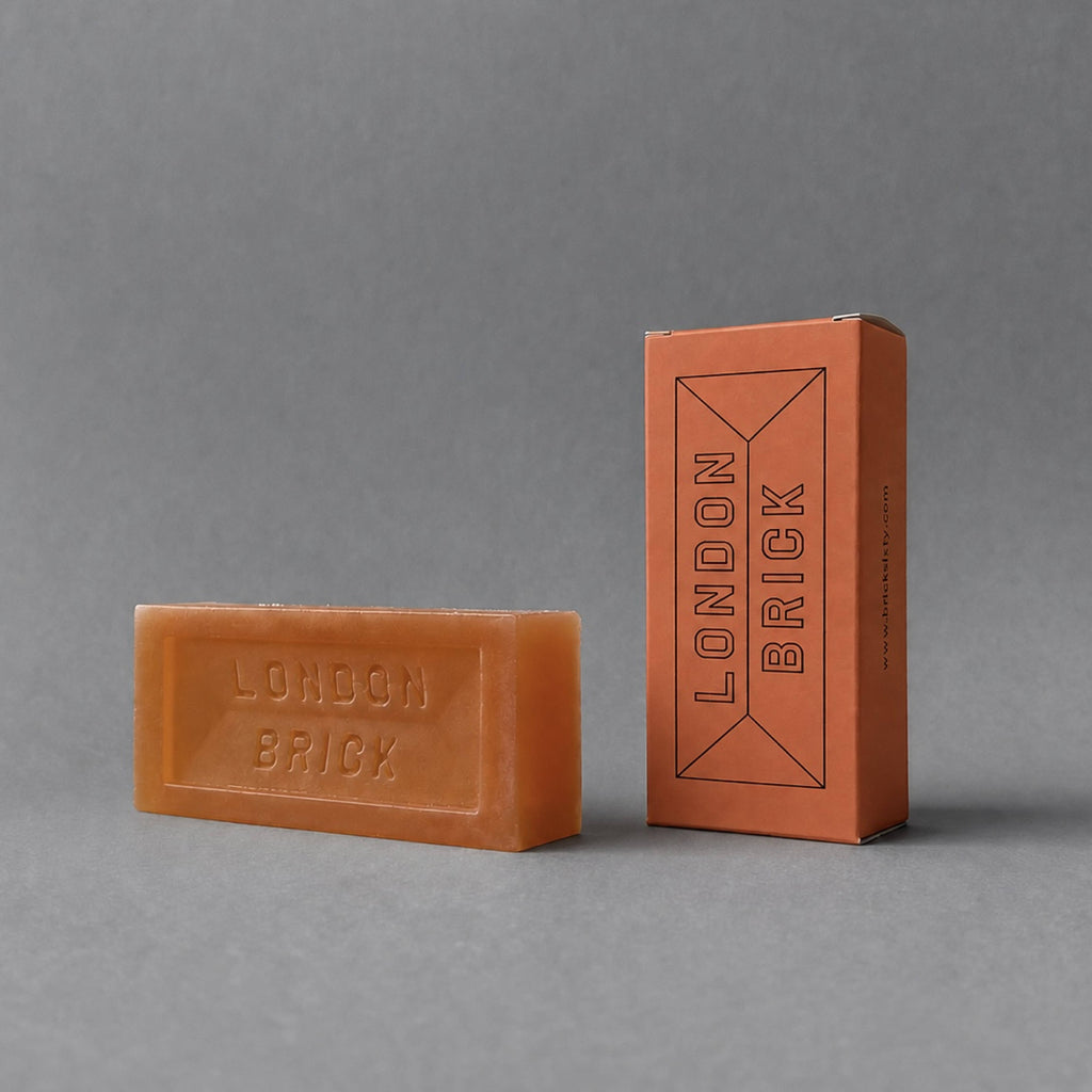 Orange brick-shaped soap bar with embossed "LONDON BRICK" lettering and box