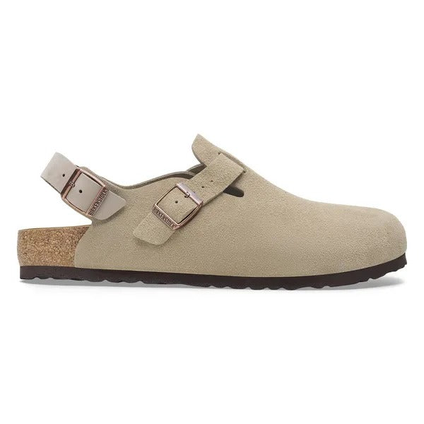 Taupe suede mule with front double buckles and cushioned lining, side view.