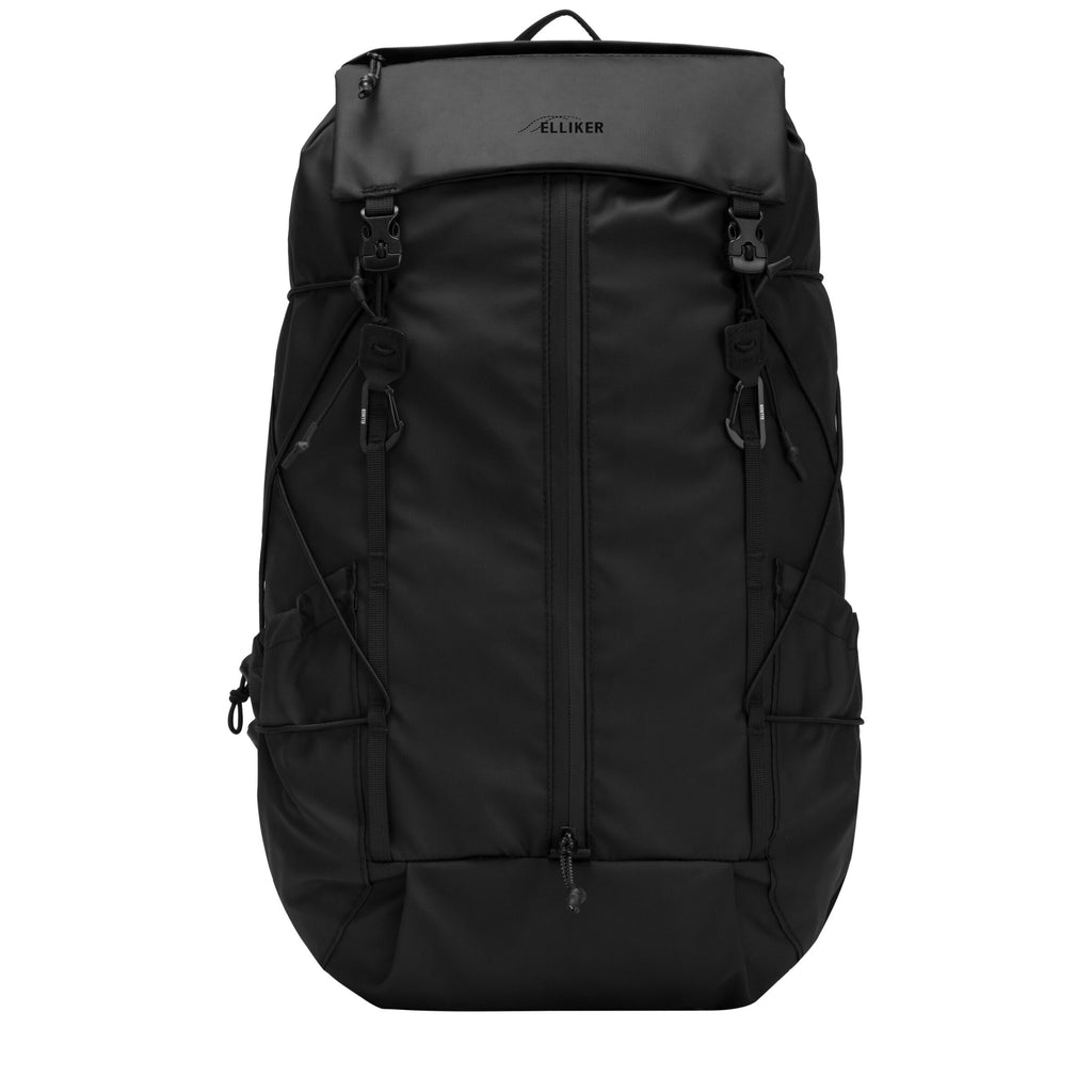 Black 23L flap-over backpack with front zip and padded straps.