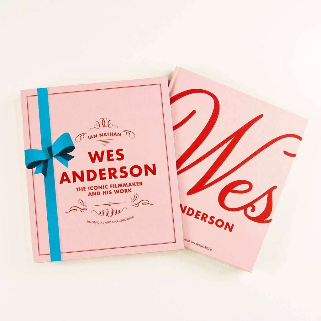 Wes Anderson book, pink hardcover with blue ribbon and title lettering on front cover