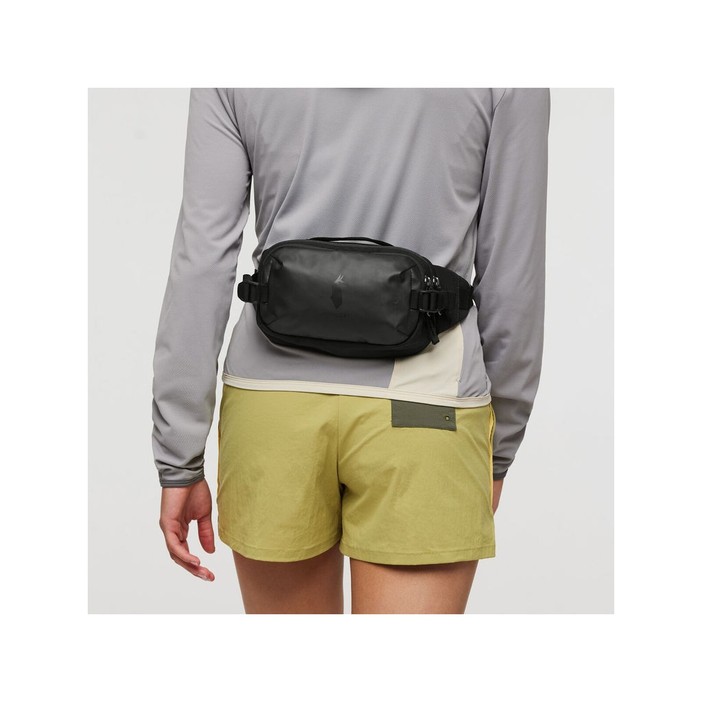 Black hip pack worn across the waist with adjustable strap and zippered bag
