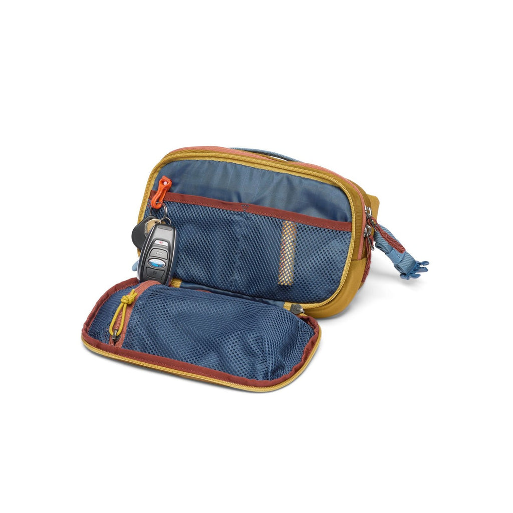 Bronze hip pack open to blue-lined organizer with zipper pocket and key clip