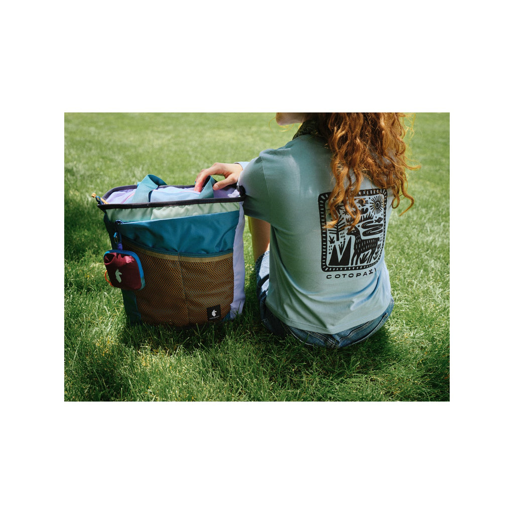 Cotopaxi Todo 22L Convertible Tote in Del Día worn as a backpack, shown in a different colour combination to illustrate that each bag is unique
