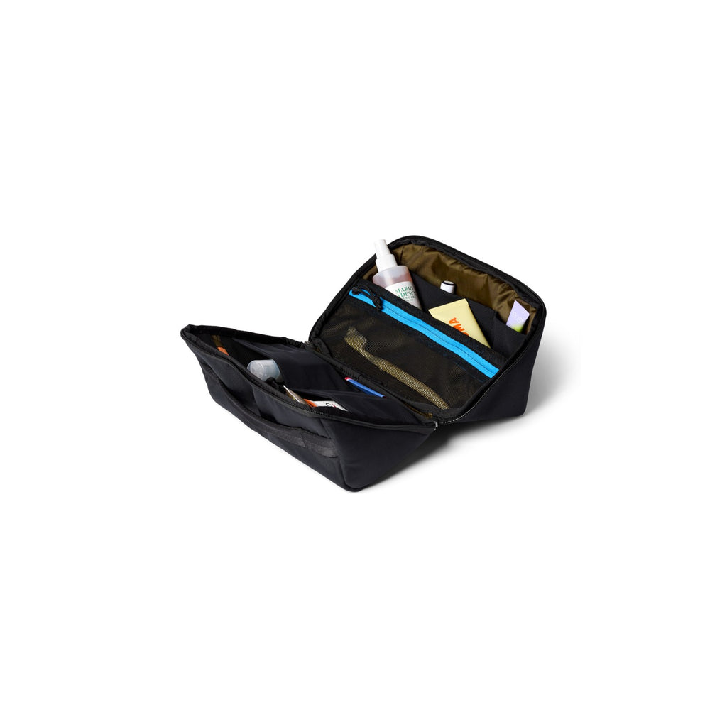 Cotopaxi Viaje Toiletry Kit in Cotopaxi Black, opened flat showing mesh pockets and elastic loops