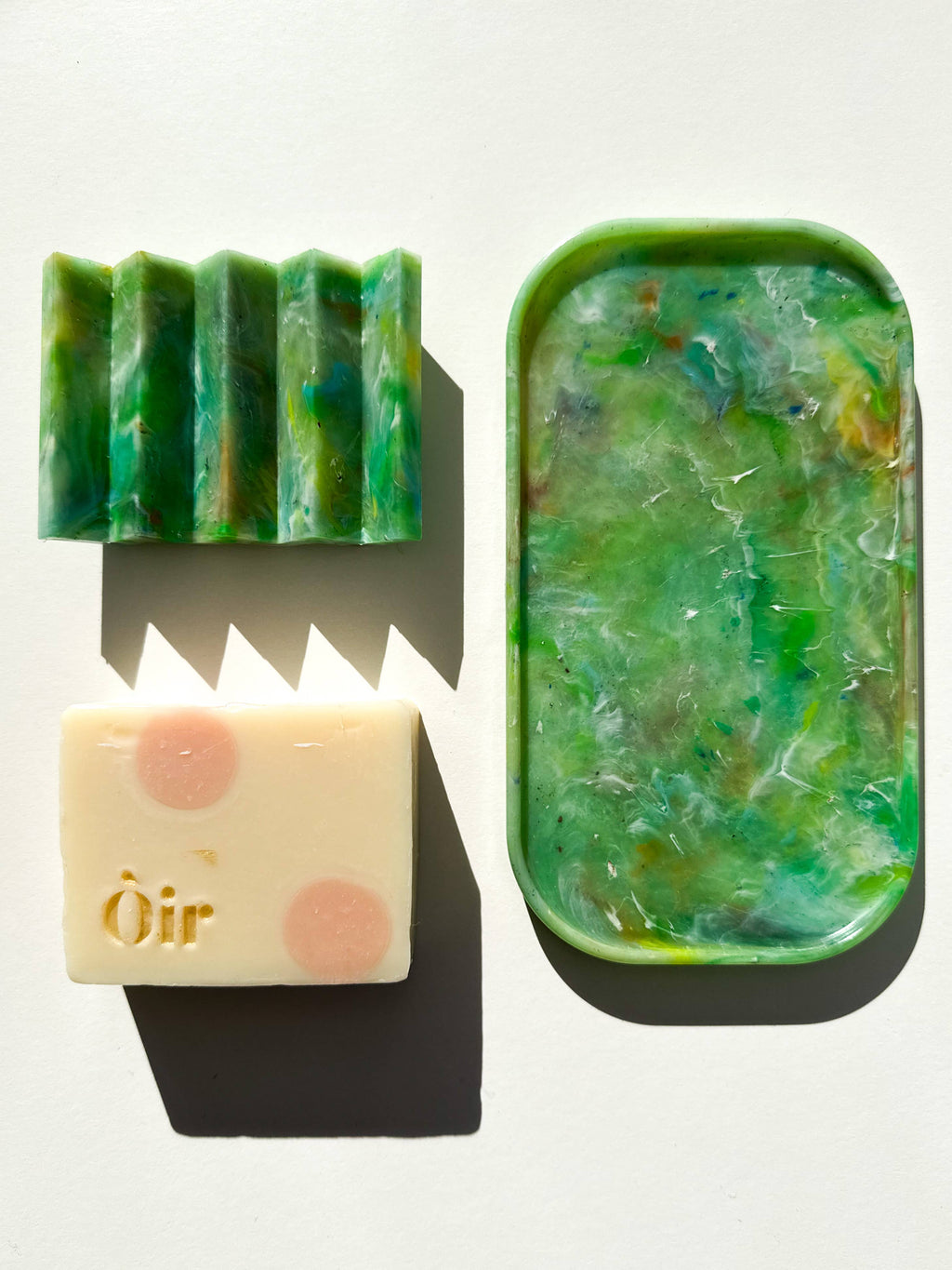 Green recycled plastic tray with curved handle, translucent marbled surface.