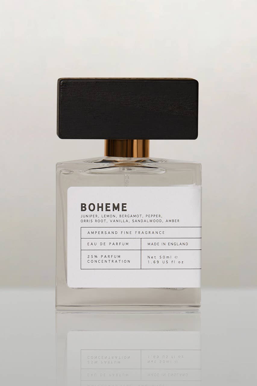 Unisex EDP perfume bottle with black cap, amber glass and white label, 50 ml