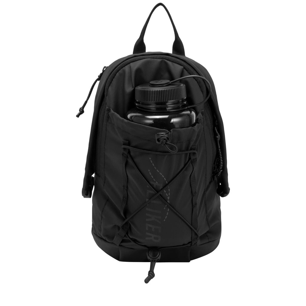 Black sling backpack with front pocket holding a water bottle and zip closure