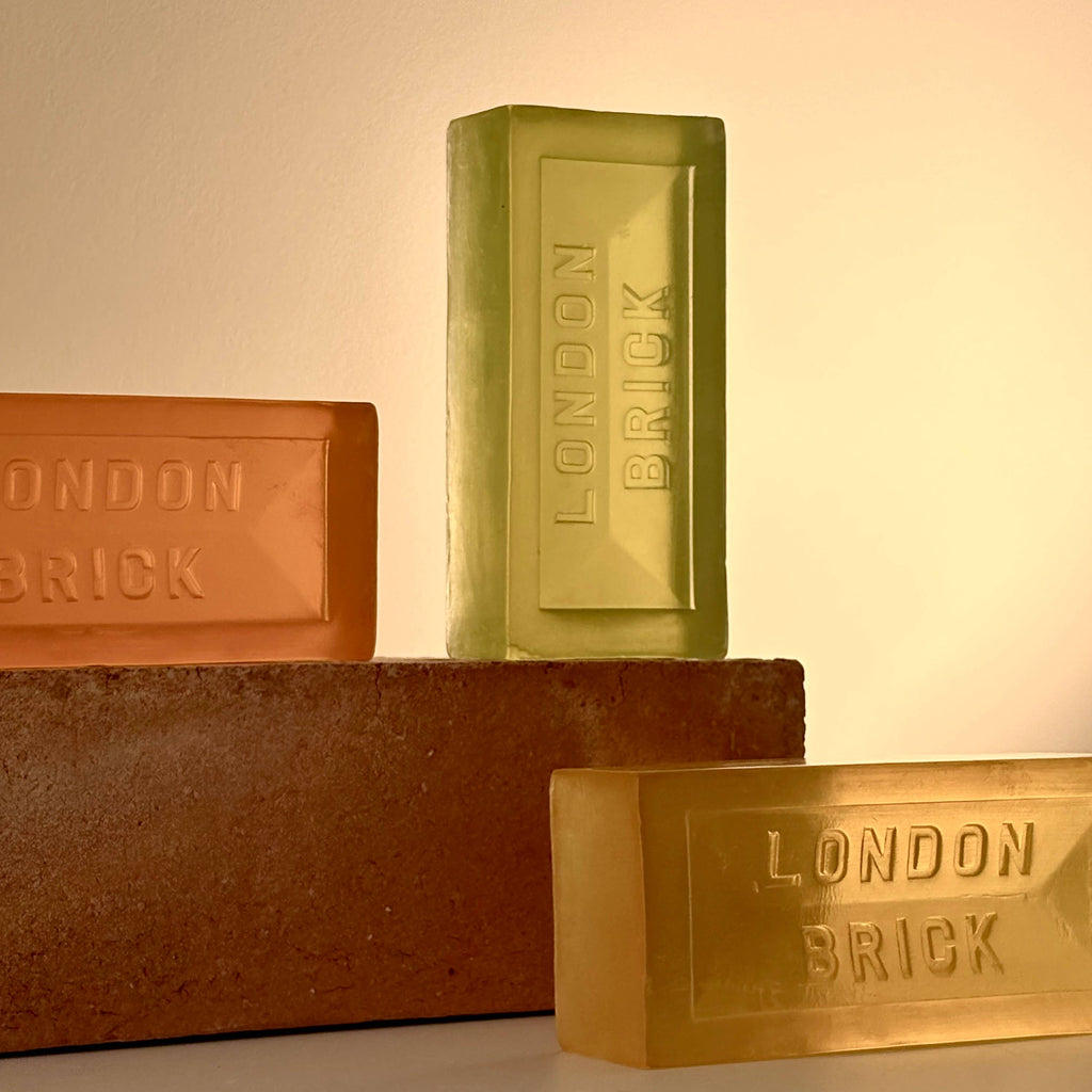 Assorted soap bars: green, brown, and orange with embossed 'LONDON BRICK' lettering.