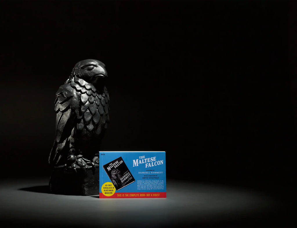 Blue book with “The Maltese Falcon” title and bird emblem on the cover.