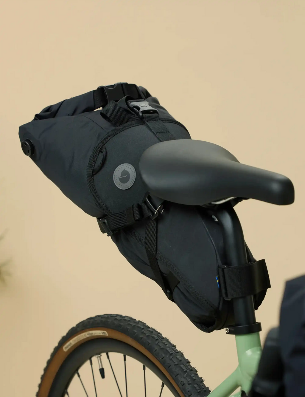 Black waterproof seat dry bag on bike frame with roll-top and straps