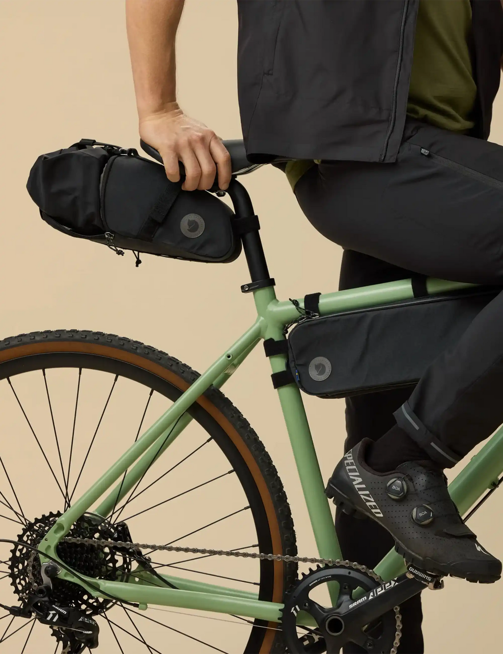 Black seatbag drybag with adjustable strap attached to bicycle