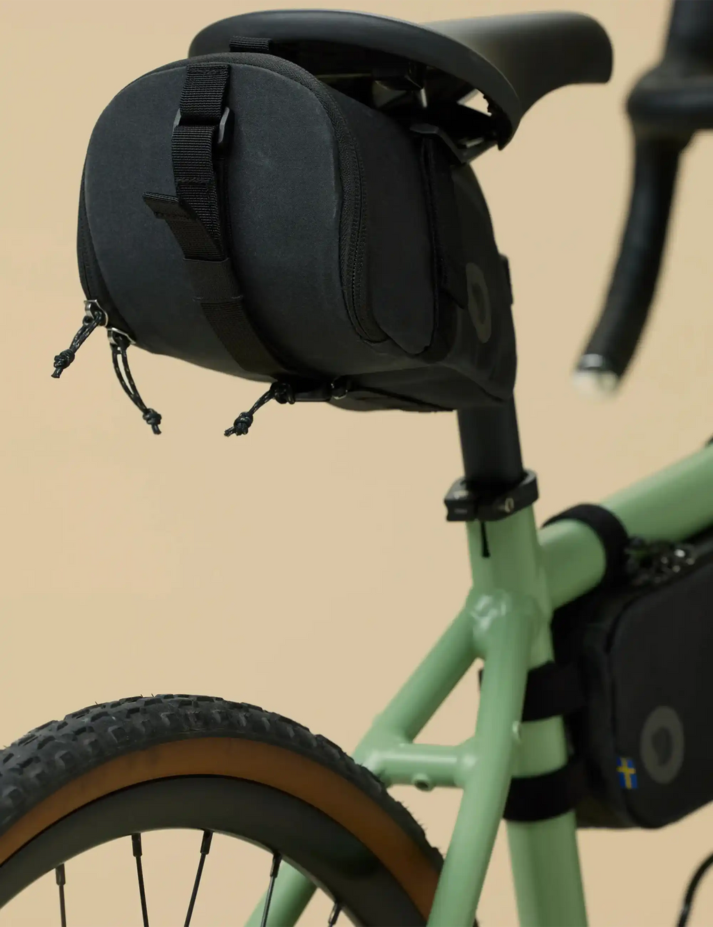 Black rear bike seat bag with straps and zippers on seatpost