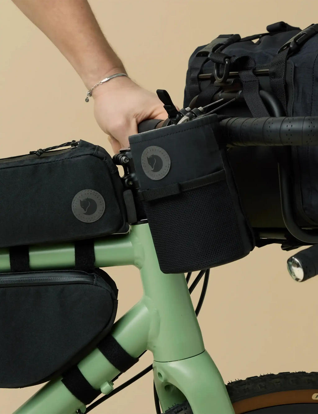 Black bike snack bag pouch with circular logo patch and adjustable webbing strap