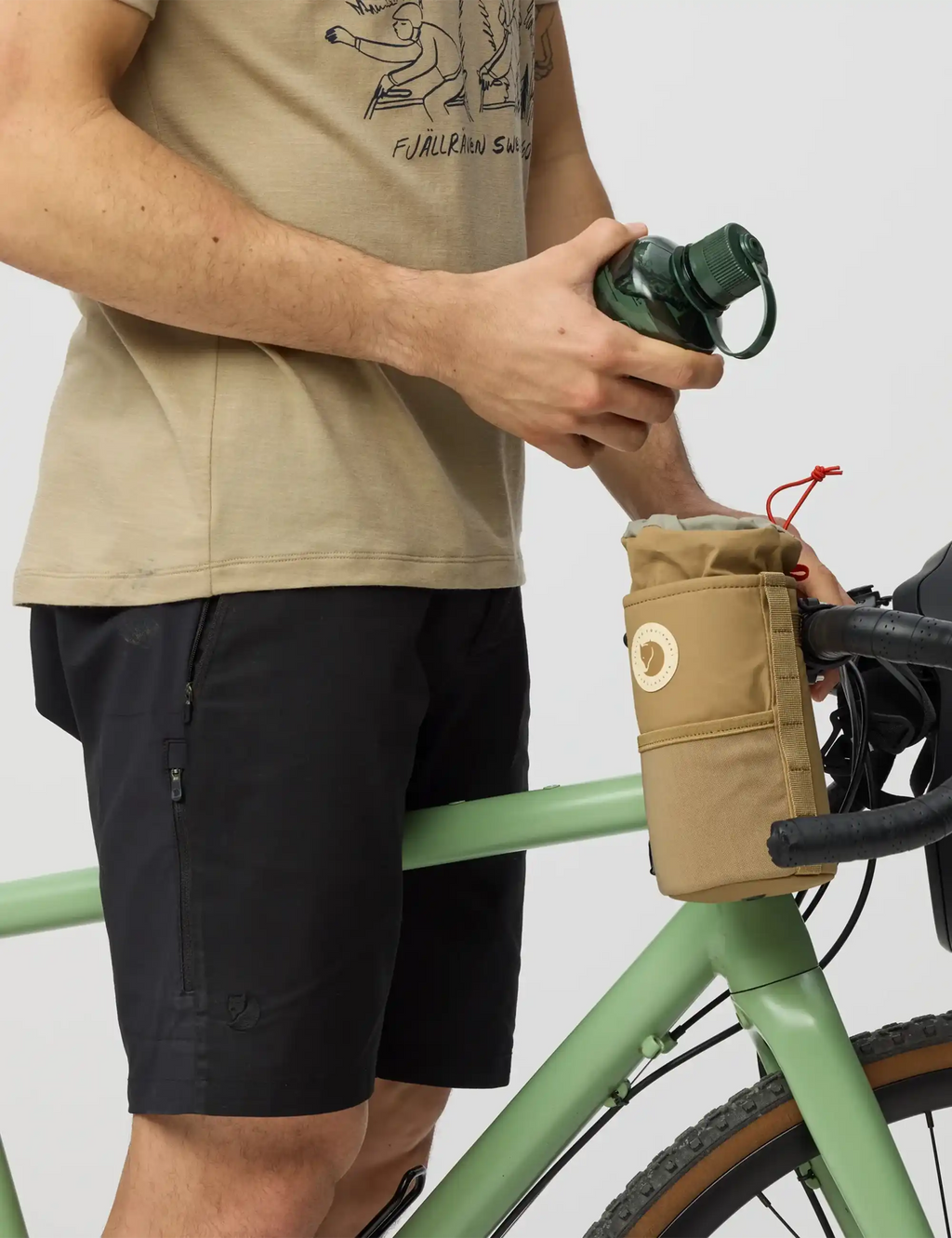Hoja large snack bag in clay mounted to bicycle handlebar with orange cord