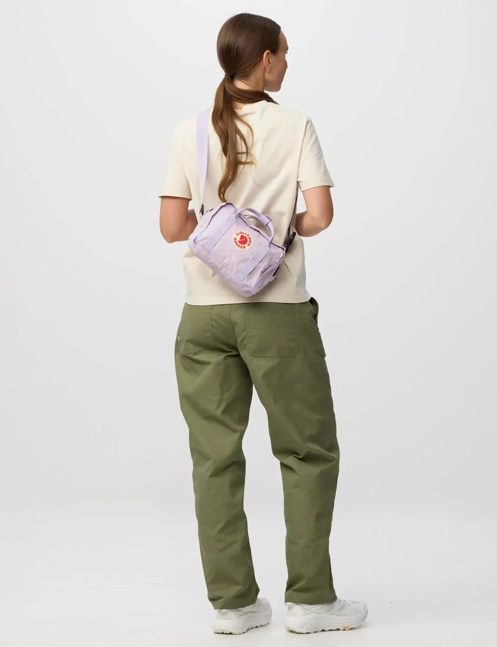 Pastel lavender crossbody bag with adjustable strap, rear view