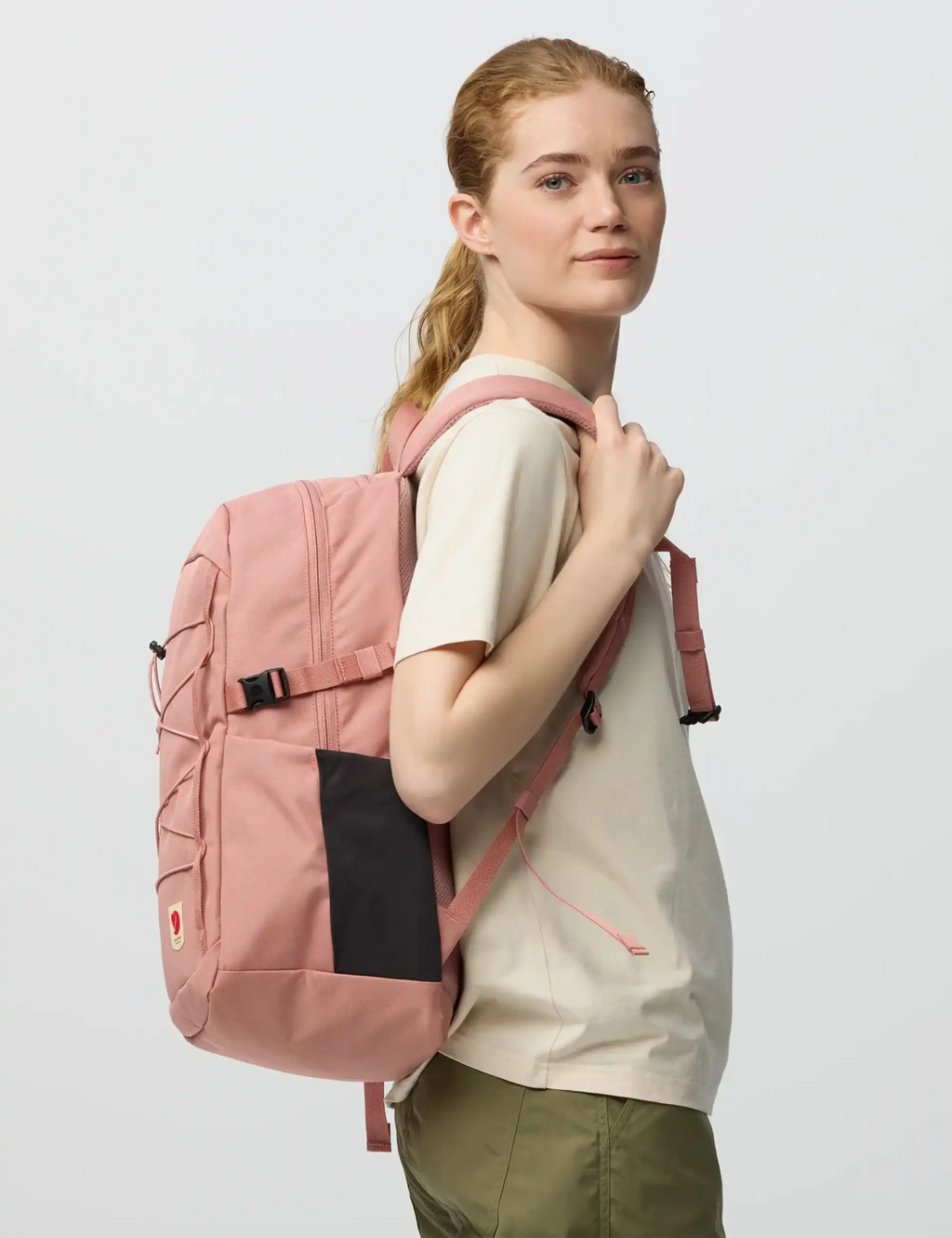Dusty rose backpack on model with side pocket and adjustable shoulder strap