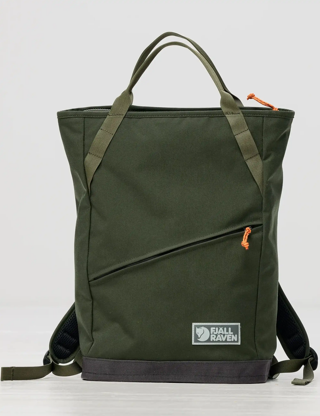 Green tote pack with top handles, diagonal front zipper pocket, and shoulder straps
